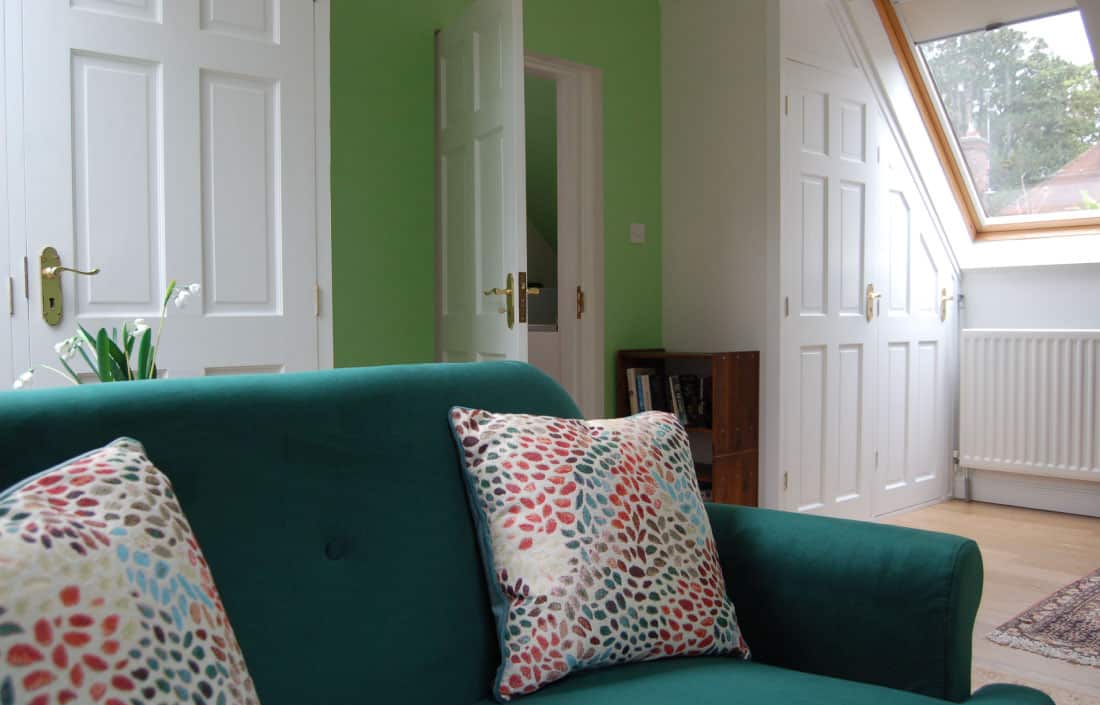 green sofa and green wall living room design in warwickshire by seasonal soul home